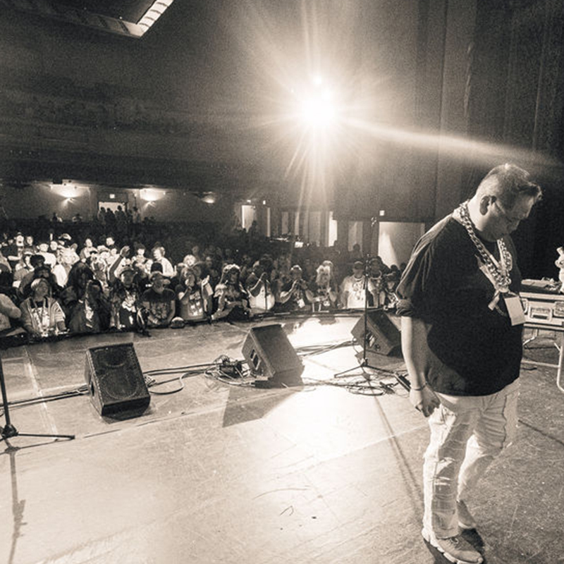 Rhyme Flow performing live on stage to a crowd